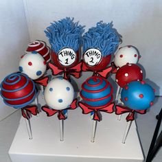 the cake pops are decorated with dr seusster's cat in the hat hats