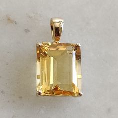 This stunning pendant is set in 14K Solid Yellow Gold with Natural Citrine with utmost precision. It is an unique gemstone pendant for nearly every occasion and is completely hassle-free jewelry. ITEM DETAILS * Gem: Citrine * Gem Size: 10X12mm * Gem Shape: Octagon  * Gem Weight: 5.55 carats * Gold Purity: 14KT  * Gold Weight: 0.99 gram * Total Weight of the Pendant: 2.10 gram The Gold purity is guaranteed and it comes with authentic 14KT gold hallmark. Since my items are handmade, they are absolutely nickel and lead free. CUSTOMIZATION * Gemstone customization is available and it can be substituted with a gem of your choice. Kindly message me for the same. PACKAGING * The Pendant comes with layers of safe and secure wrapping along with Free handmade jewelry box with every purchase. ➡️Head Yellow Gold Citrine Gemstones For Gift, Octagon Citrine Jewelry For Gifts, Octagon-shaped Yellow Jewelry For Gift, Yellow Octagon-shaped Jewelry Gift, Citrine Gemstones With Accent Stones For Gift, Yellow Gold Gemstone With Accent Stones As Gift, Yellow Gemstones With Accent Stones For Gifts, Sunny Disposition, Yellow Hues