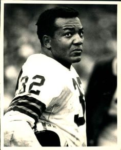 an old black and white photo of a football player