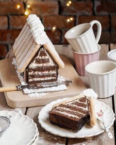 a slice of cake sitting on top of a white plate next to a cup and saucer