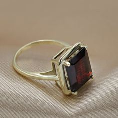 An Absolutely gorgeous Red  Garnet Gold ring. Featuring a Prong set 6.5 Carat 10 x 12 Red  Garnet  natural  Gemstone.The color is simply amazing as well as the clarity, This is a Grade AAA corundum Gemstone.When i saw the beauty of this gemstone i had to have it, I simply had to buy a few and make a few rings with them i could not escape its beauty!Each ring is hand made to your order from start to finish with the utmost attention to details, service and finish.We only have a few of these marvel Garnet Gold Ring, Red Gemstone Ring, Solitaire Ring Set, January Birthstone Rings, Red Garnet Ring, Garnet And Gold, Garnet Jewelry, Red Gemstones, Garnet Ring