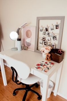 a white desk with pictures on the wall