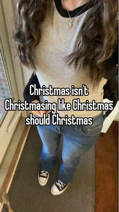 a girl standing in front of a window with the words christmas isn't christmas like christmas