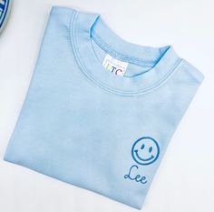 Smiling face t shirt Sizes 12 mo and up. For boys or girls Listing includes name Nice, thicker cotton boutique quality t shirts If you don't see a size here that you need, I will be glad to check to see if I have it. Please message me for questions. Pre-shrunk Crew Neck Top For Daycare, Playful Blue Tops With Name Print, Fun Blue Tops With Name Print, Fun Blue Top With Name Print, Smiling Face, Smile Face, Quality T Shirts, Short Girls, Custom Color