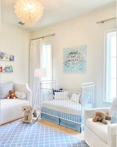 a baby's room with blue and white decor