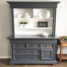 an old dresser is painted gray with white trim