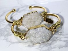 Perfect gifts for moms, birthdays, graduations and especially bridesmaids gifts!  My  unique handcrafted bracelets are the perfect accessory to any outfit.  These can be worn alone, but in my book, the more, the merrier!   *Natural Druzy gemstone  *18k Gold plated cuff *Wire wrap All my bracelets will have a slight variation due to the unique nature of the gemstones, so no two bracelets are ever 100% alike!   Each bracelet comes in its own pouch.  Great for keeping them in a safe and secure place, especially when traveling! Thank you for supporting a mom and her dreams ;) Follow me on Instagram and say hi @ instagram.com/samandgracejewelry Bohemian Wedding Bracelets With Jewels, Bohemian Wedding Bracelet With Jewels, Chic Handmade Bracelets As Gift, Elegant Stackable Cuff Bracelet Gift, Bohemian Cuff Bracelet For Weddings, Chic Silver Bracelets For Wedding, Bohemian Wedding Cuff Bracelet, Gold Bohemian Beaded Bracelets For Gifts, Gold Bohemian Beaded Bracelets As Gift