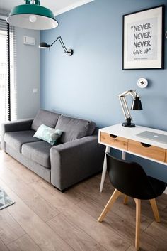 a living room with blue walls and wooden floors