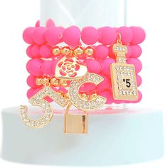 Matte Fuchsia Pearl Bead Stretch Bracelet Set Featuring Designer Inspired Rhinestone Number 5 and Boutique Charms for women. Perfume Charm measures 1.15 inches. 5 Pcs Set. Pink Letter Beads Jewelry For Party, Pink Letter Beads Bracelet For Party, Rhinestone Statement Necklace, Memory Wire Bracelets, Pink Plastic, Bangle Bracelets With Charms, Number 5, Anklet Bracelet, Boutique Accessories