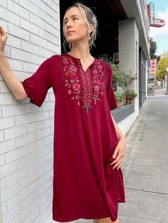 "Handcrafted in a sumptuous silky rayon, the Josefina dress features an easy slip on fit with princess seams in the bodice, ample width in the hip, petal bell sleeve, and rich hand embroidered details on the front and neck. Designed longer, by customer request, the center back length is 39\" for size S. Pre-washed, machine washable. Fair trade verified. Model is 5'9 size S. *Embroidery may vary slightly due to the handcrafted nature of the garment." Flowy V-neck Embroidered Dress, Embroidered V-neck Rayon Dress, Rayon V-neck Dress For Festival, V-neck Rayon Dress For Festival, Festive Short Sleeve Embroidered Dress, Traditional Festive Rayon Dresses, Festive Traditional Rayon Dresses, Bohemian Midi Dress With Floral Embroidery And Short Sleeves, Bohemian Midi Dress With Chikankari Embroidery