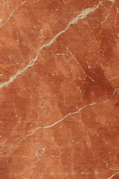 an orange marble floor with white lines on it