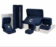 an assortment of jewelry is shown in blue and white boxes with matching rings on them