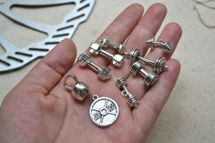 If you like DIY and a fitness fan here are some nice charms for you. Dumbbell ,Kettlebell, Barbell,Weight Plate Charm etc There are suit for making necklace,bracelet,keychain etc. Material: Alloy,lead and nickel free Color: Antique Silver Size: very small Quantity : 1 set (9pcs in total,1pcs per charm) Packing: opp bag packing Barbell Weights, Bracelet Keychain, Charm Collection, Bag Packing, Stylish Bracelet, Snap Jewelry, Charm Pack, How To Make Necklaces, Kettlebell