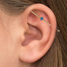 a close up of a person's ear with a piercing