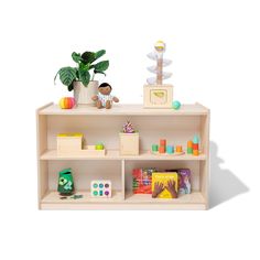 a wooden toy shelf with toys on it and a potted plant next to it