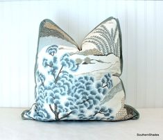 a blue and white pillow sitting on top of a table