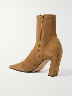 Find KHAITE Nevada Suede Ankle Boots on Editorialist. KHAITE's 'Nevada' ankle boots are inspired by classic cowboy styles. They've been crafted in Italy from soft, stretchy suede and have slanted heels that offer 85mm of lift. Wear them with midi dresses or slim jeans. Chic Fitted Ankle-high Chelsea Boots, Fitted Chelsea Boots With Almond Toe For Fall, Fitted Suede Heeled Boots With Square Toe, Designer Ankle Boots For Fall, Fall Pointed Toe Boots With Medium Fit, Luxury Fitted Ankle-high Heeled Boots, Luxury Fitted Heeled Boots With Stacked Heel, Fall Medium Fit Boots With Pointed Toe, Fitted Ankle-high Heeled Boots With Leather Sole