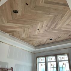 an unfinished ceiling with wood planks in the middle