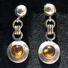 Amber and silver vintage drop stud earrings Sterling silver stud earrings featuring a round Amber cabochon on each drop     * 1 x round Amber stone per earring     * length 28mm from top of stud to base of drop     * width 11mm at widest point    PLEASE NOTE: THIS ITEM IS PRE-OWNED. Please follow the link below to view more of our vintage items: https://www.etsy.com/uk/shop/IceniSilvercraft?ref=seller-platform-mcnav&section_id=29025188 Dope Jewelry, Sterling Silver Stud Earrings, Amber Stone, Silver Stud Earrings, Amethyst Stone, Earrings Sterling Silver, Sterling Silver Studs, Sterling Silver Earrings Studs, Gorgeous Earrings