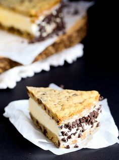 two pieces of cheesecake sitting on top of paper napkins next to each other