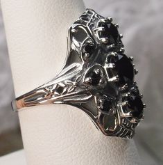 Black Cubic Zirconia Ring Description 9Gem Design#69 Made To Order Inspired by the Art Deco movement, I now offer this gorgeous Art Deco 1930s reproduction filigree ring in sterling silver. This ring is marked 925 for solid sterling. This lovely filigree ring is set with 3 central stunning center round cut Black CZ gemstones; 6mm center, 4mm top/bottom. 6 more round cut 2mm gemstones also grace the sides of the setting. Notice the beautiful design of the silver filigree setting and band. The rin Classic Black Diamond Rings For Formal Occasions, Antique Jewelry With Prong Setting For Vintage Occasions, Art Deco Sapphire Ring With Prong Setting, Classic Wedding Rings With Black Diamonds, Vintage Black Diamond Round Ring, Classic Black Diamond Ring Jewelry, Classic Jewelry Ring With Black Diamonds, Vintage Silver Sapphire Ring With Diamond Cut, Vintage Black Round Diamond Ring