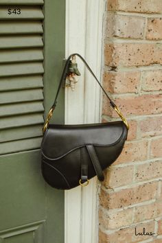 Elevate your look with a tasteful piece like the Lulus Equestrian Aesthetic Black Saddle Bag! Sleek faux leather shapes this chic purse that has a saddle bag-style profile, with a slim strap and gold-toned horse bit accents. Dangling accent at the front adds a unique touch, atop an asymmetrical flap that opens with twin magnetic closures. Roomy interior boasts a zippered sidewall pocket, perfect for tiny essentials. Carry it over your shoulder with the purse strap, or use the detachable crossbod Luxury Travel Bags, Black Saddle Bag, Luxury Travel Bag, Black Saddle, Saddle Handbags, Saddle Bag Purse, Equestrian Aesthetic, Chic Purses, Equestrian Chic