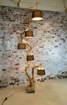 a lamp that is next to a brick wall with three lamps on top of it