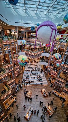 an overhead view of a library filled with lots of books and people sitting at tables