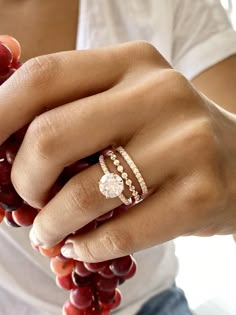 a woman's hand with two rings on it