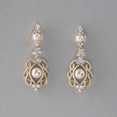 two pairs of earrings with pearls and diamonds on the bottom one is gold, the other is white