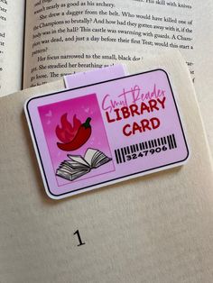 a close up of a book with a library card attached to the back of it