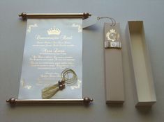 the wedding stationery is set up with gold and white paper, pearls, and jewelry