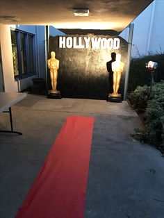 the entrance to hollywood's oscars is decorated with red carpet and two golden statues