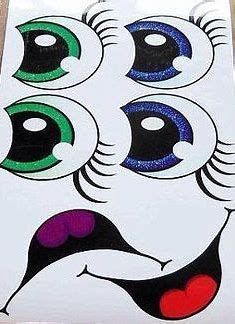 an assortment of different colored eyes on white paper