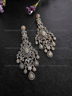 Statement chandelier earrings with an intricate Victorian design. Made with highest quality CZ diamonds and expert craftsmanship. Ideal for weddings and parties. Length - 4.25 inch Width - 1.75 inch Weight - 23 gm each ----------- CARE ----------- - Store in air tight zip lock bags - Do not expose to moisture/water - Do not spray chemicals or perfumes on the jewelry Please feel free to contact us if you have any questions. * We sell high quality imitation jewelry only. All measurements are approximate. Please note that all sales are final. Thank you Wedding Crystal Diamond Earrings Pierced, Wedding Diamond Crystal Earrings Pierced, Pierced Diamond Crystal Earrings For Wedding, Diamond Danglers With Matching Earrings For Wedding, Luxury Bollywood Chandelier Earrings Gift, Wedding Crystal Diamond Earrings (pierced), Diamond Chandelier Dangle Earrings For Celebration, Exquisite Diamond Chandelier Earrings For Pierced Ears, Ornate Pierced Danglers For Wedding