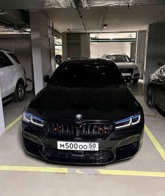 two cars parked in a parking garage next to each other