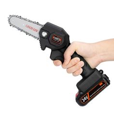 a person is holding a chainsaw in one hand and a cordless saw in the other