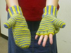 a woman wearing yellow and blue knitted gloves