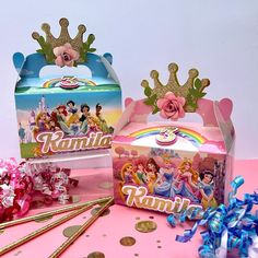 there are two boxes with princesses on them and confetti in the box