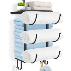 a towel rack with four towels hanging from it's sides and one shelf holding several folded towels