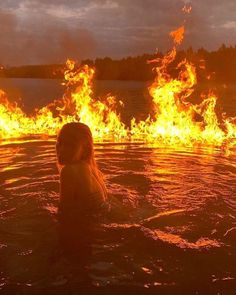 a woman in the water with fire coming out of her face