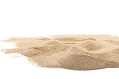 a pile of sand sitting on top of a white surface