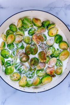 brussel sprouts are being cooked in a pan on the stove top