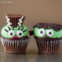 three cupcakes with green frosting decorated like characters