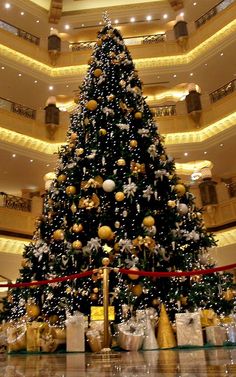 a large christmas tree in the middle of a building