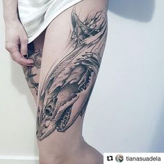 a woman's leg with a tattoo on it and a dragon in the middle