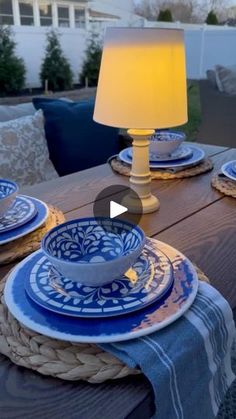 the table is set with blue and white plates