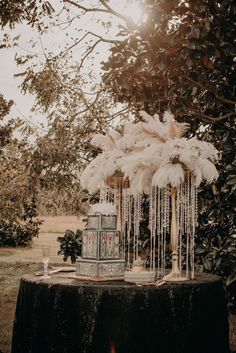 a table topped with a cake covered in icing next to a forest filled with trees