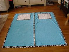 a blue and white blanket on the floor