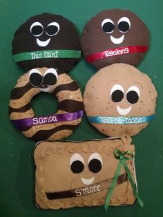 four donuts decorated to look like they are smiling